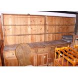 A 19th century pine dresser with boarded back fitted shelves, over base fitted five drawers and