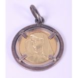 An Italian yellow and white metal pendent depicting the Virgin Mary, stamped 750, 5.8g gross