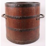 A bushel bucket with metal fittings and carrying handles