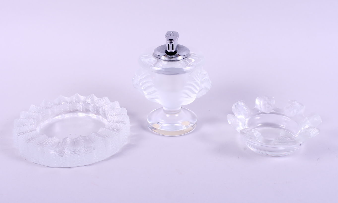 A Lalique double lion head table lighter and two Lalique ashtrays