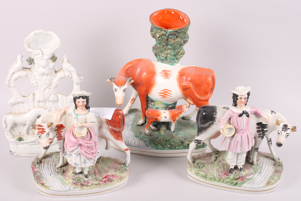 A pair of 19th century Staffordshire figures with cattle, 8 1/2" high, a cow and calf spill vase, 11