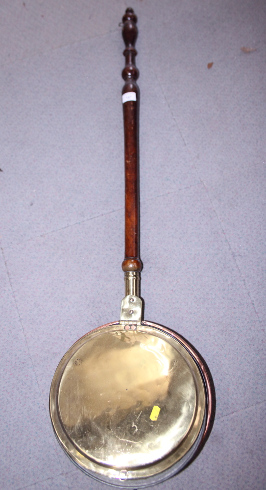 A copper and brass warming pan