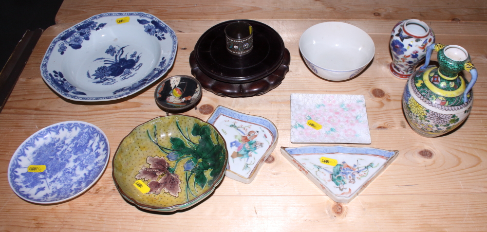 A 19th century Chinese export blue and white dish, a hardwood stand and other Oriental ceramics,