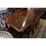 A Victorian mahogany extending dining table with two leaves, on reeded and castored supports, 40"