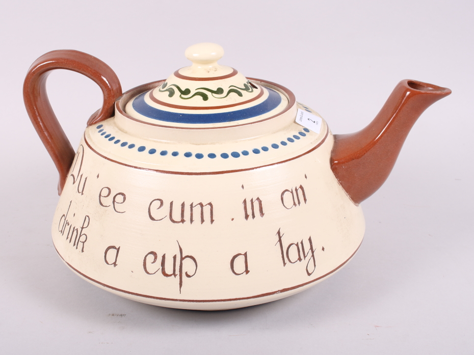 A Torquay Ware teapot, inscribed "Du ee cum in an drink a cu a tay", 14" wide (small chips to