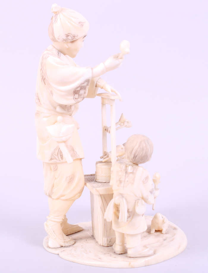 A Japanese sectional ivory okimono of a toy seller with children, 6 1/4" high - Image 4 of 7