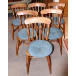 A set of six Windsor spindle back chairs with panel seats, on turned and stretchered supports