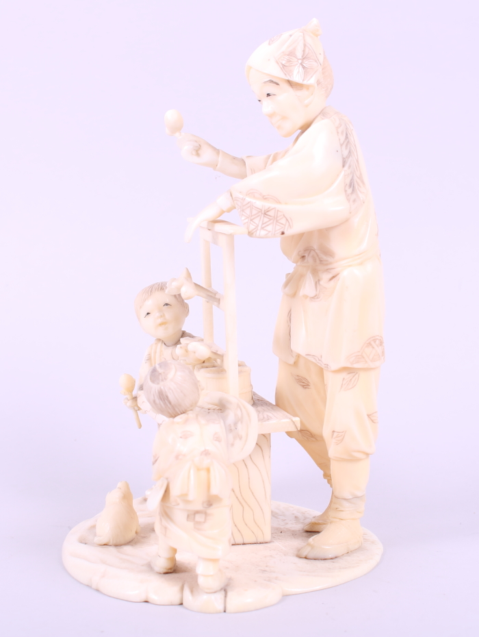 A Japanese sectional ivory okimono of a toy seller with children, 6 1/4" high - Image 2 of 7