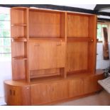 A G-Plan three-section display and dresser unit with flanking corner shelves over cupboards, 97"