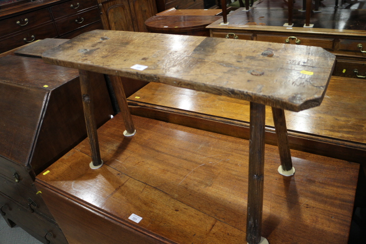 A late 19th century oak "pig" bench, on splay supports, 31 1/2" wide x 17" high