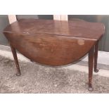 A Georgian mahogany circular drop leaf dining table, on pole turned supports and pad feet, 48" dia
