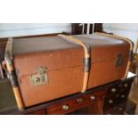 A brown canvas and wooden travelling trunk, 32" wide x 12 1/2" high