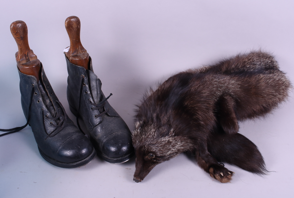 A pair of leather boots and a fox fur stole
