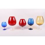 Four oversized brandy balloons, in various colours, largest 10 1/4" high