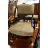 A late 19th century ebonised shape frame low seat nursing chair, upholstered in a sage velour, on