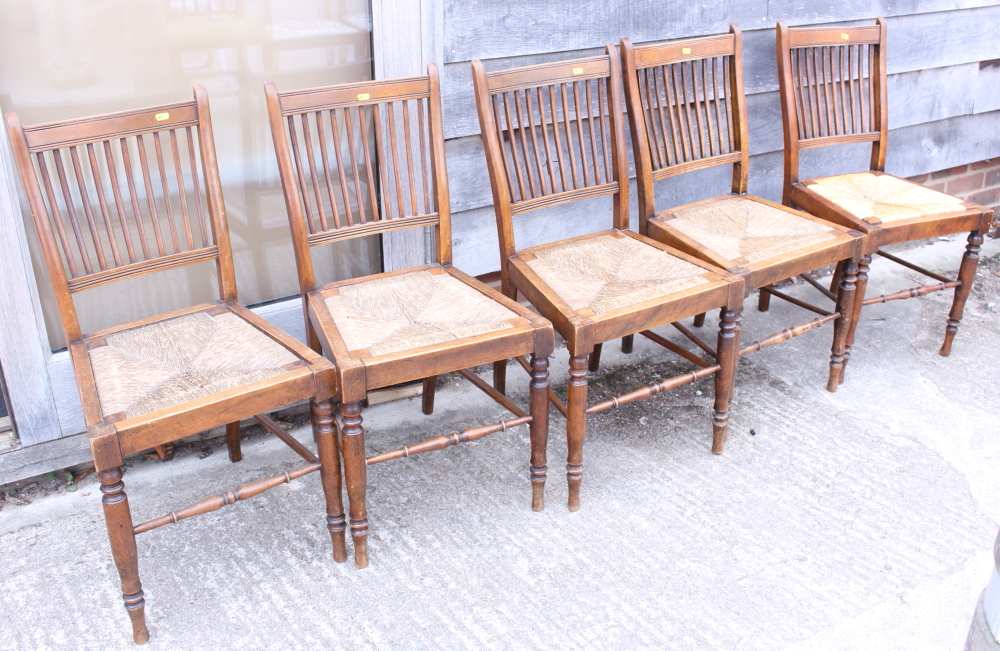 Five oak rush seat chairs, on turned supports, and a mahogany chair, upholstered in a green