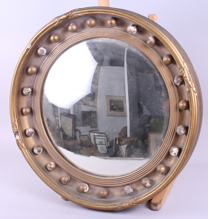 A gilt framed circular convex wall mirror