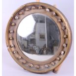 A gilt framed circular convex wall mirror