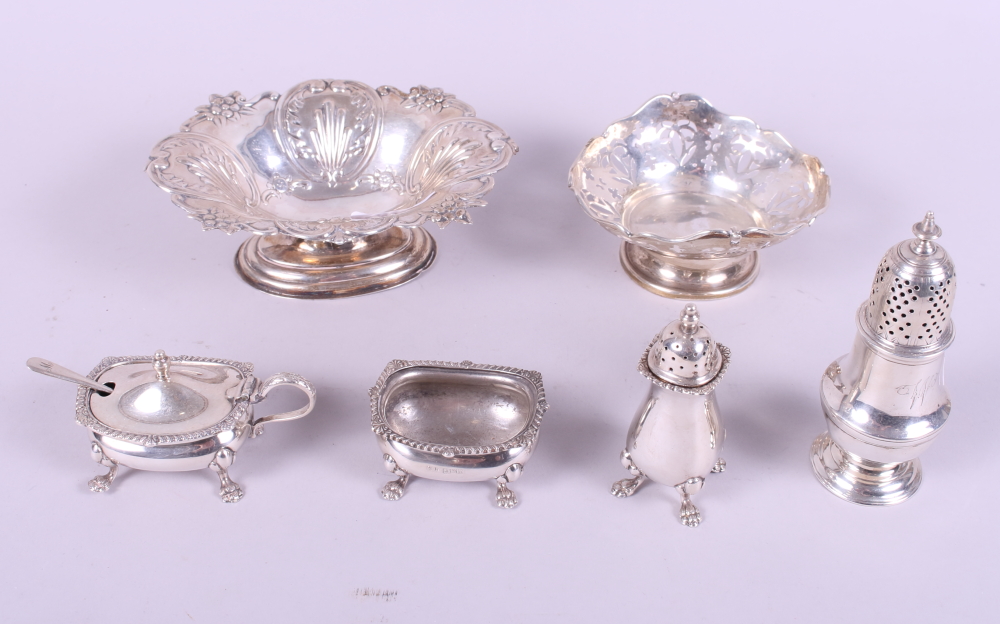 A silver three-piece cruet set, two silver bonbon dishes and a silver muffineer with weighted