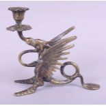 A brass chamberstick, in the form of a grotesque dragon, 6 1/2" high
