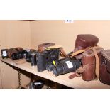 A pair of Carl Zeiss 8x32B binoculars, a pair of military binoculars, two other pairs of