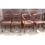 A set of twelve William IV mahogany and inlaid bar back dining chairs with stuffed over seats,