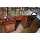 A late 19th century mahogany double pedestal desk with green tooled leather top, fitted nine