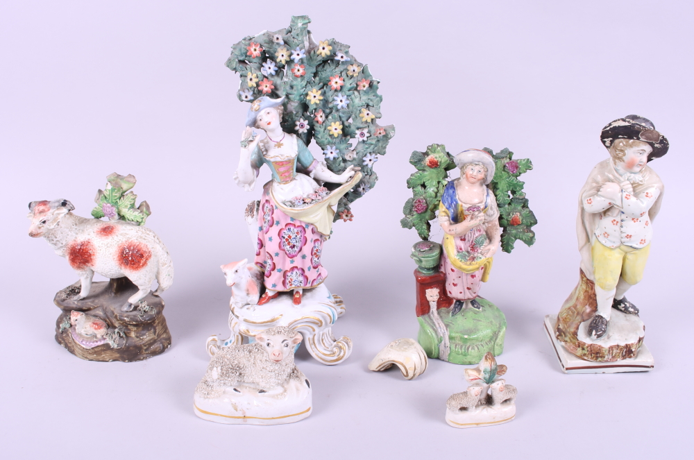 A late 18th century figure "Winter", 7" high, a similar figure with flowers, three sheep groups