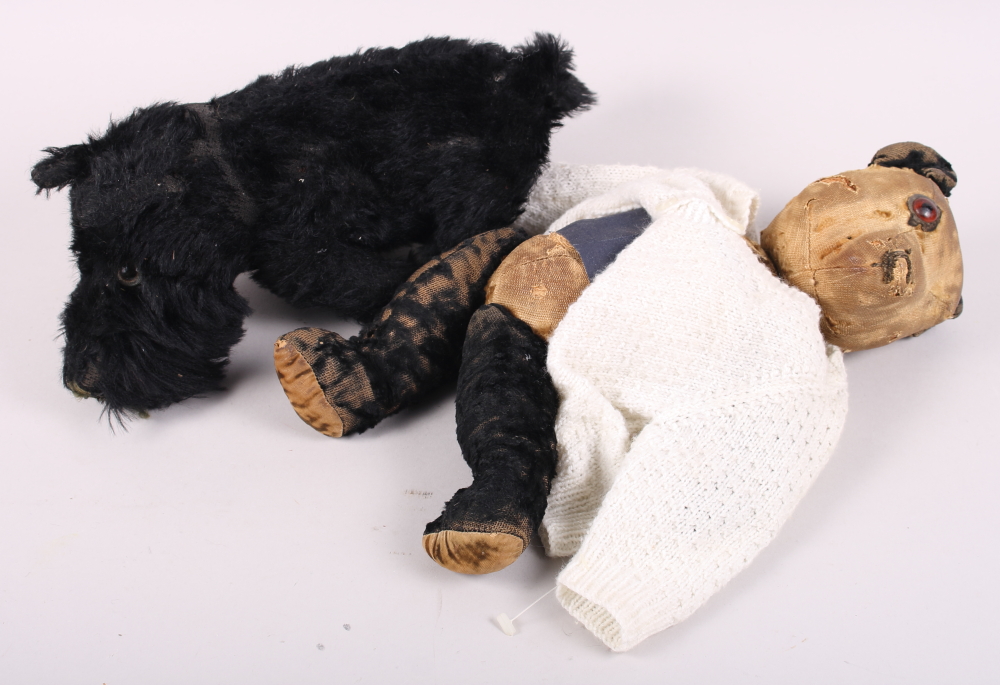 An early 20th century straw filled teddy bear and a West Highland Terrier soft toy