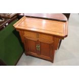 A Chinese hardwood side cabinet, fitted one drawer over cupboards, 22" wide