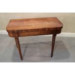 A Victorian mahogany fold-over top card table, on turned and stretchered supports, 36" wide