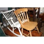 A white painted rocking chair and a Windsor stick back kitchen chair