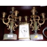 A pair of gilt metal and onyx five-branch candelabra and a Jonelle brass cased carriage clock