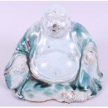 A Chinese glazed pottery figure of a seated Buddha, 6 1/2" (chipped nose)