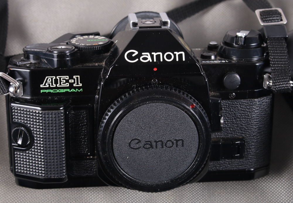 A Canon AE-1 "Program" camera with a FD 135mm lens, a Canon FD 50mm lens, a Canon Ranger Auto 2X, FD - Image 6 of 7
