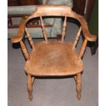 A captain's 19th century oak, ash spindle back elbow chair with elm panel seat, on turned and