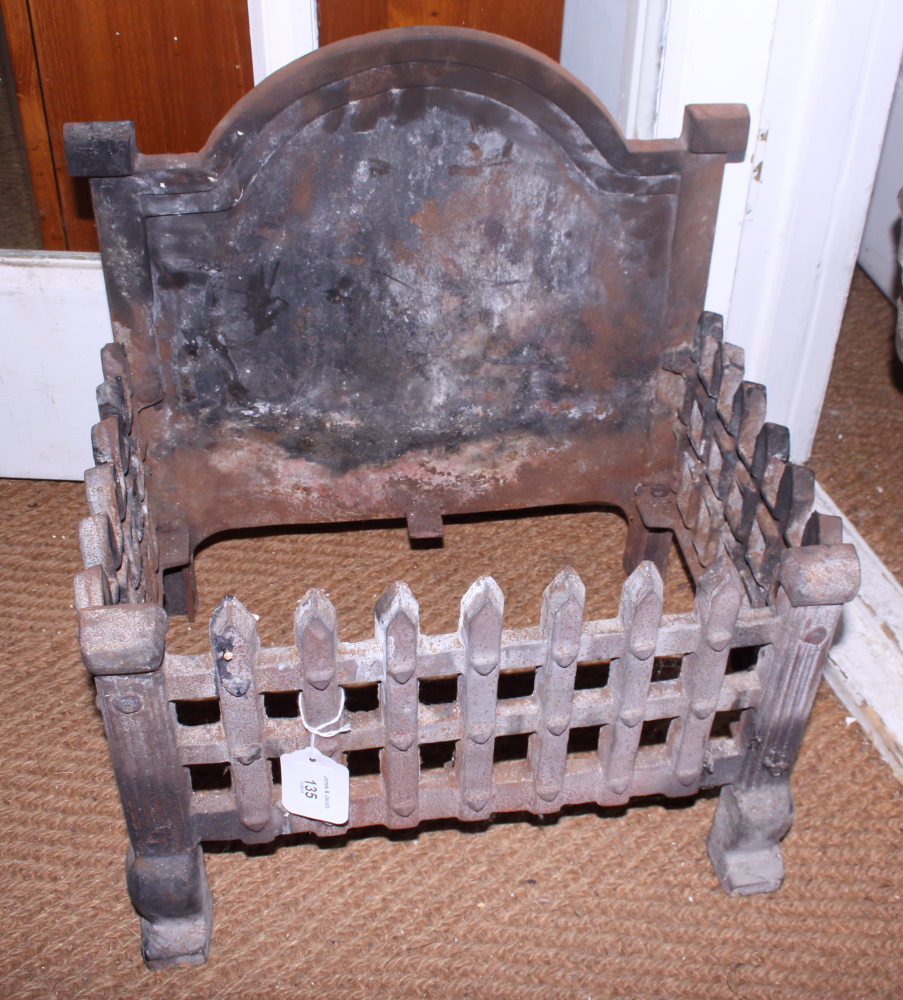 A rectangular fire grate with arched top, 15" wide
