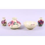 An early 20th century Moorcroft "Hibiscus" pattern squat vase, 4 1/2" high, and three other