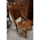 An early 20th century mahogany rocking chair and a cane seat side chair