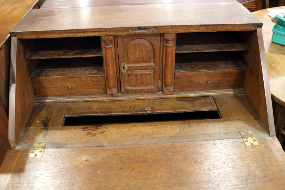 An 18th century oak provincial fall front bureau with fitted interior with well, over two drawers - Image 2 of 3