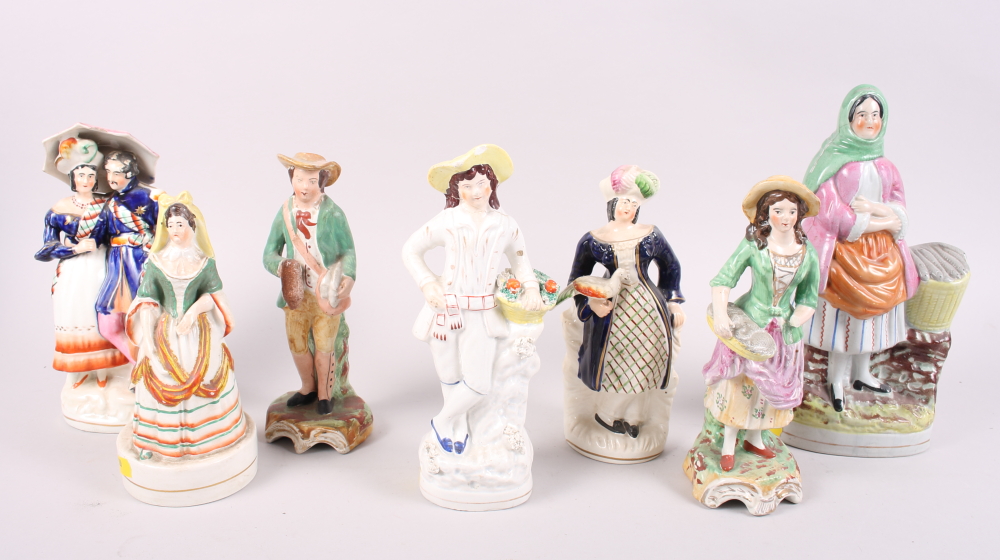A 19th century Staffordshire figure, fish wife, a smaller figure, Spanish lady, and five other