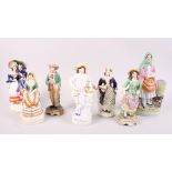 A 19th century Staffordshire figure, fish wife, a smaller figure, Spanish lady, and five other