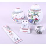 A pair of Chinese porcelain ginger jars and covers, a porcelain wrist rest, a miniature vase and a