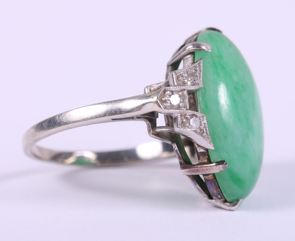 An Art Deco white metal ring, set jade cabochon, flanked three diamonds to each shoulder, ring - Image 2 of 10