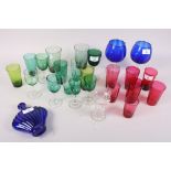 A selection of cranberry and green drinking glasses, two Bristol blue brandy balloons, a similar