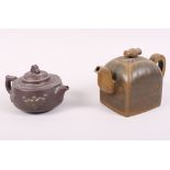 A Chinese Yixing pottery teapot, decorated bats, seal mark to base, and a similar larger