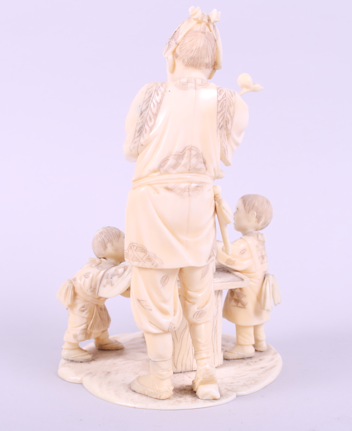 A Japanese sectional ivory okimono of a toy seller with children, 6 1/4" high - Image 3 of 7