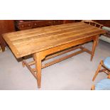 A 19th century stripped pine plank top kitchen table, on square tapered supports, 79" x 32"