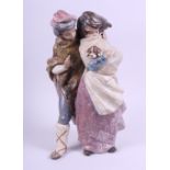 A Lladro Gres figure group of a young boy and girl holding a small dog, 13 12" high