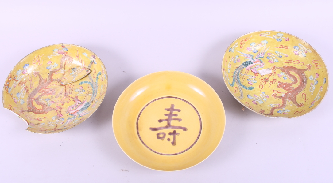 A pair of Chinese porcelain dishes, decorated dragons on a yellow ground, six character marks to